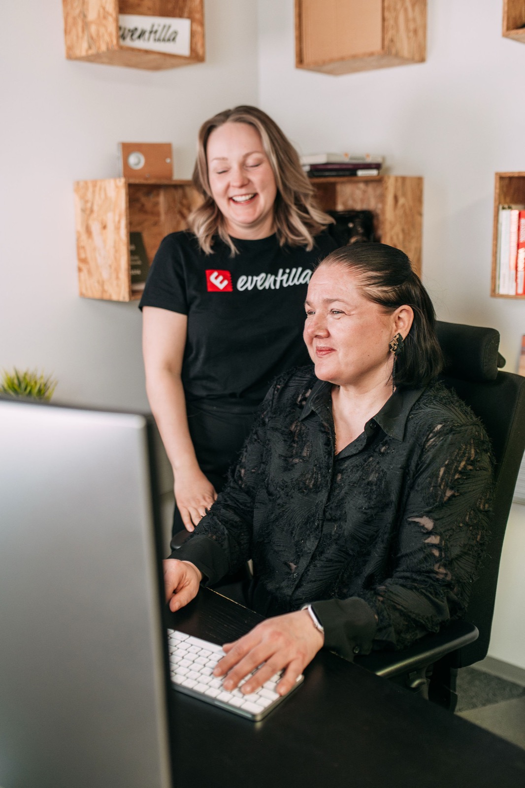 Two CompetenceFlow colleagues reviewing records together at a screen in the Oulu office in Finland