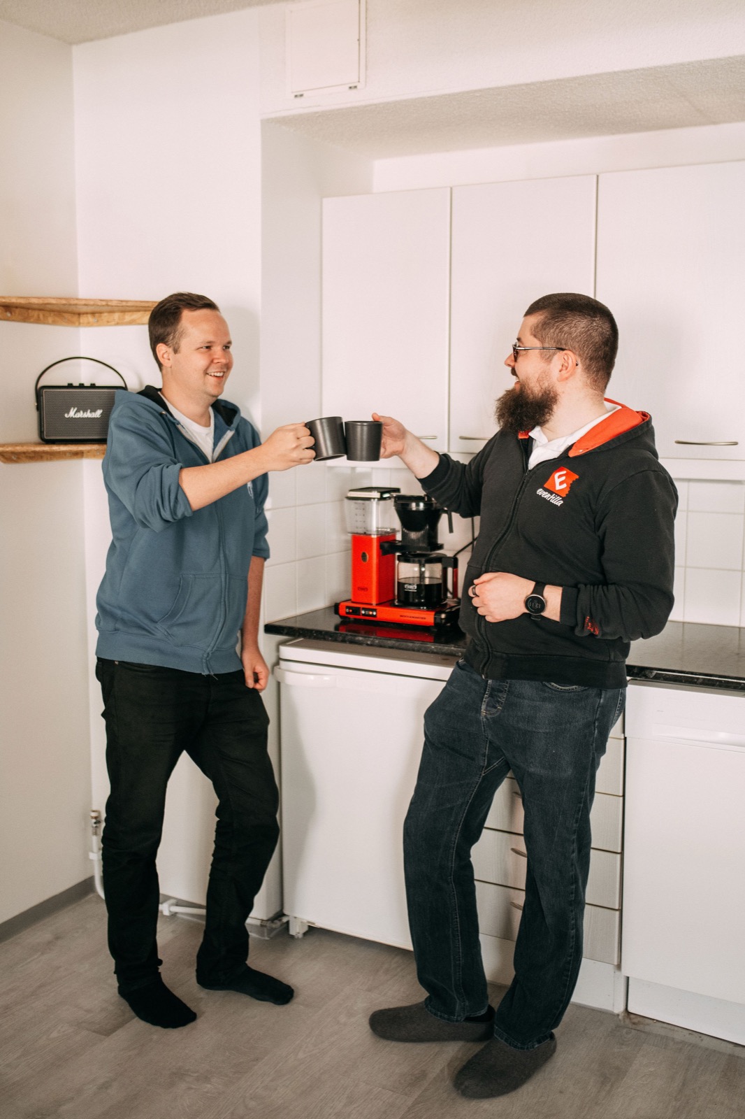 Two CompetenceFlow colleagues sharing coffee in the office kitchen in Oulu, Finland