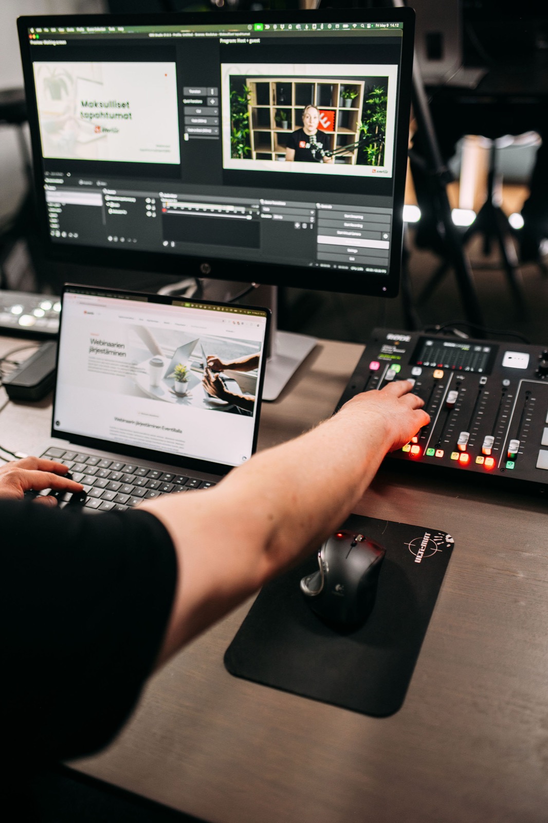 A CompetenceFlow team member working with broadcast equipment and a laptop in the Oulu office in Finland