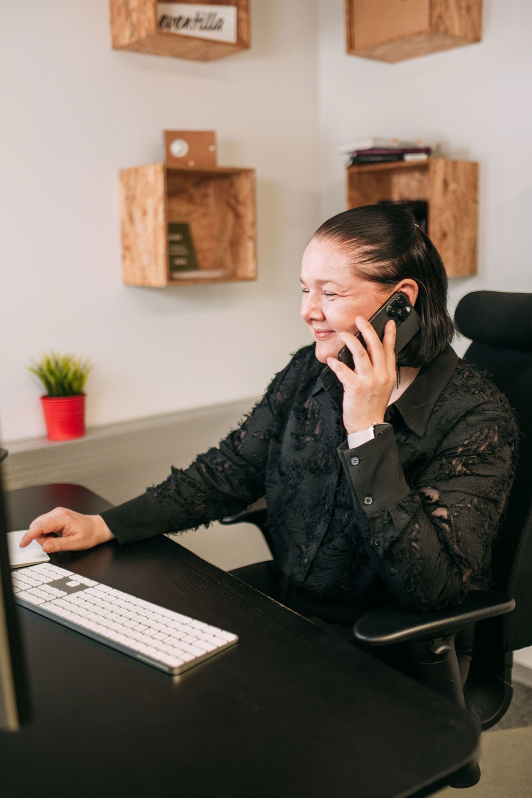 A CompetenceFlow team member on a phone call at her desk in the Oulu office in Finland