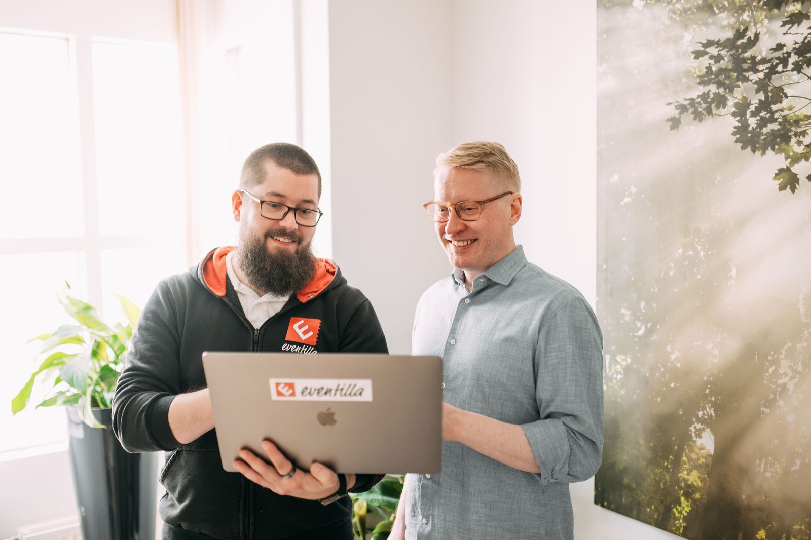 Two members of the CompetenceFlow team working through a task on a laptop at the Oulu office in Finland